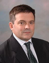 Picture of Dr. Gonzalo Echavarria in a suit smiling at the camera