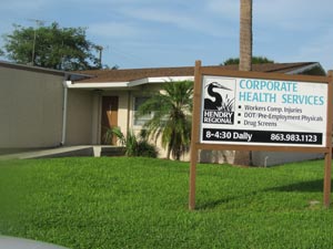 Picture of The Hendry Regional Corporate Health Building with a Palm Tree outside of the building